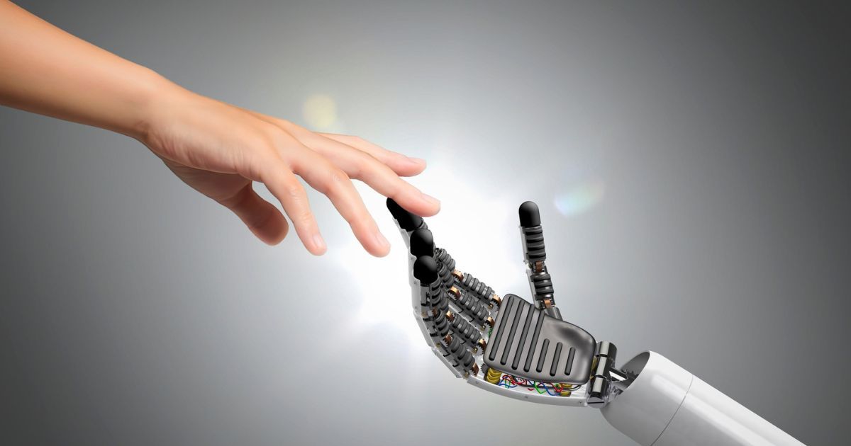 A human hand reaching toward a robotic hand